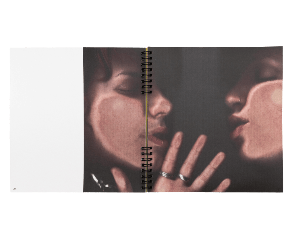 Interior spread of GUTMAG Issue 2: DOUBLES showing two people facing one another across the exposed twin-loop binding.