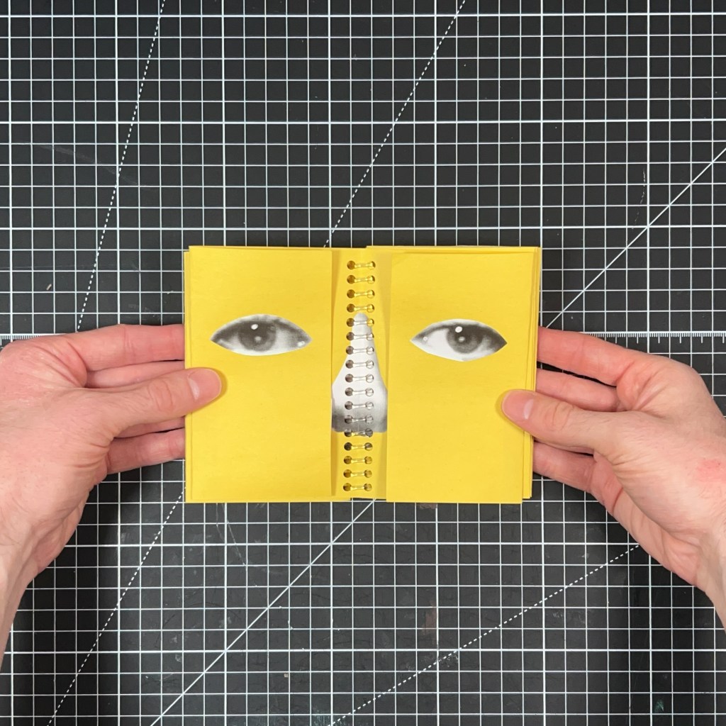 Open yellow spread from Blink and You’ll Miss It with collaged eyes and a receipt-paper nose divided by transparent spiral binding.